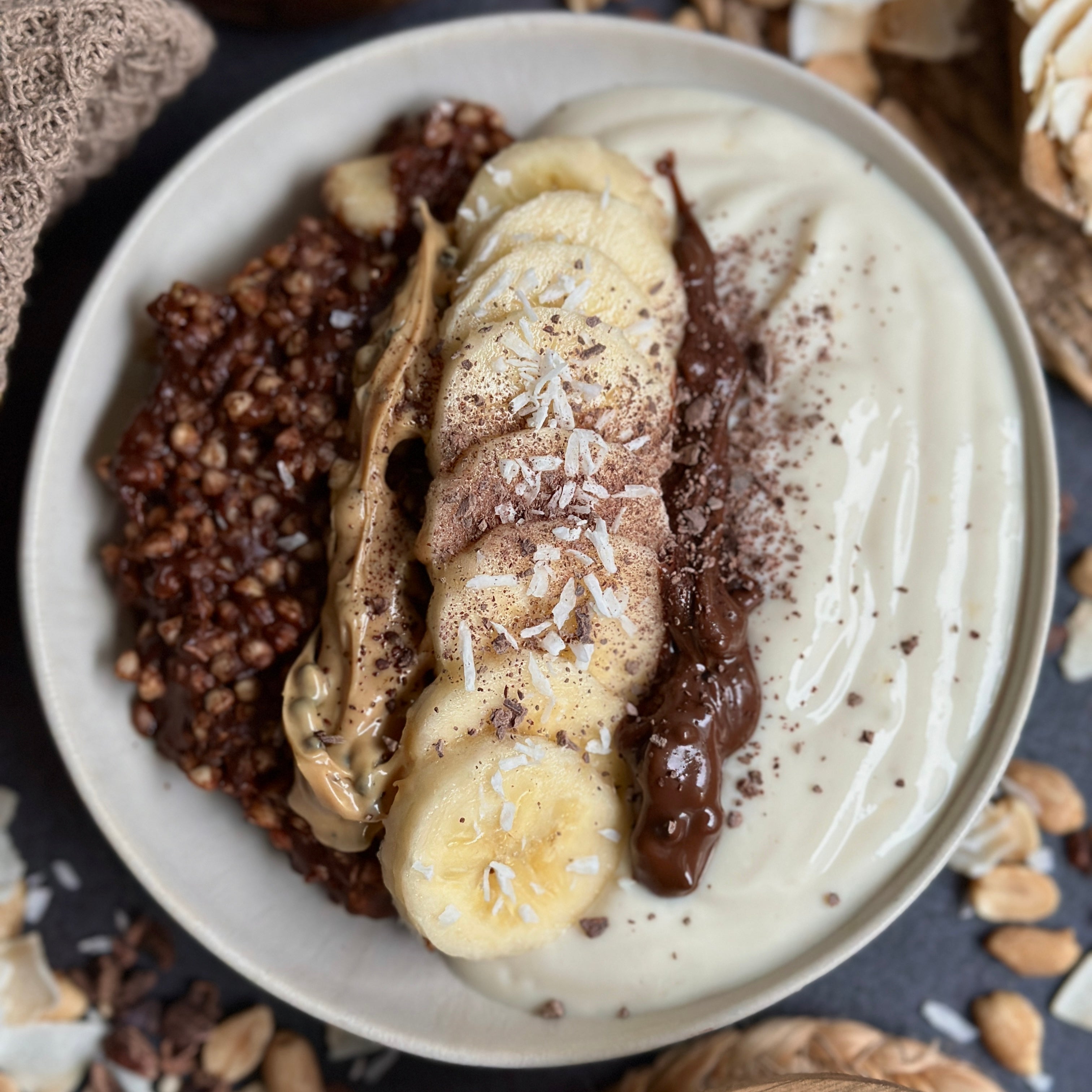 Schoko-Kokos Buchweizen Porridge in einer Schüssel mit cremiger Kokos-Vanille-Creme und Gain Kitchen Vanille Spread – gesundes, proteinreiches Frühstück ohne Zucker.